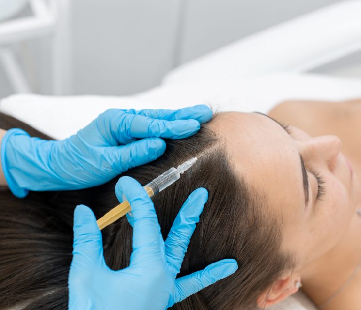 Beautician injections for healthy hair growth. Mesotherapy of the scalp. A young girl is undergoing a course of spa treatments in the office of a beautician. Moisturizing, cleaning and facial skin
